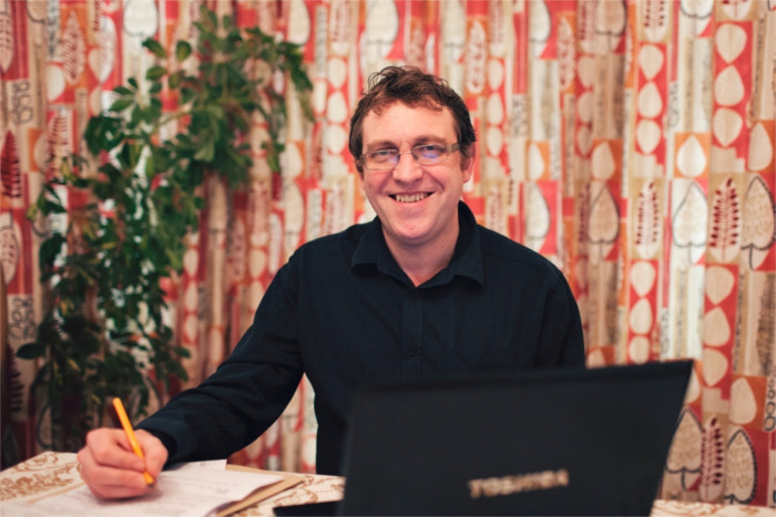 Picture of Paul Cowham sitting at his desk - Information about Paul Cowham - Paul Cowham Accountancy - Manchester based accountant specialising in the charity and social enterprise sectors